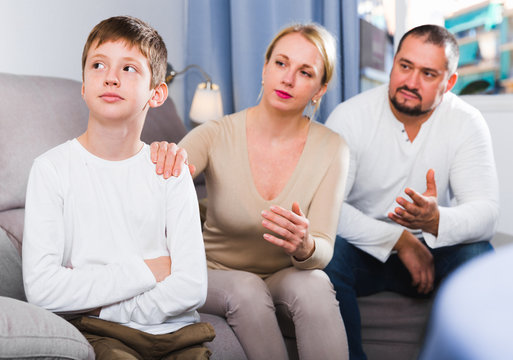 Upset boy scolded by parents