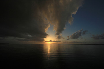 Naklejka na ściany i meble Rainy sunrise over the calm waters of Card Sound, Florida.
