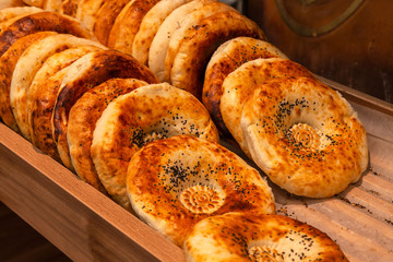 Close-up of tandyr bread cakes freshly baked appetizingly laid out in even rows on the counter of a...