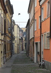 Fototapeta premium Narrow medieval street in the center of Ferrara, Italy