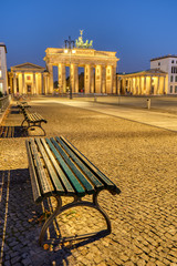 The Pariser Platz in Berlin at dawn with the illuminated Brandenburg Gate in the back © elxeneize