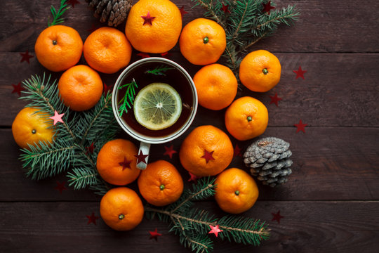 Christmas new year background with tangerines, tea and sweets on the table. winter still. selective focus.