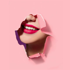 Beautiful red lips in pink paper frame. Plump lips, woman face. Smile, white teeth