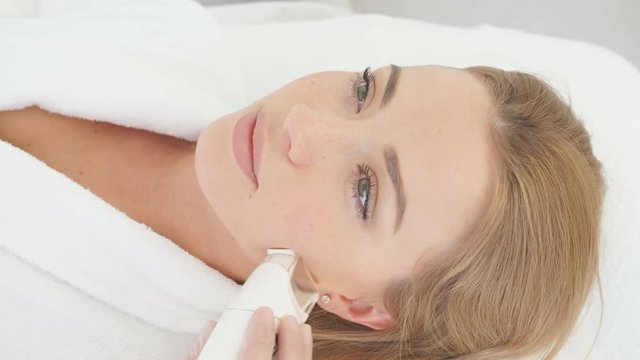 Attractive young groomed woman pampers herrself with a facial or a body treatment in a luxury spa and beauty salon. Fractional laser dermal resurfacing have proven to be effective at clinic