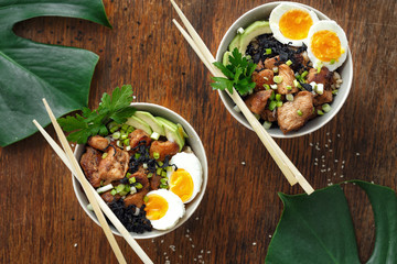 Asian food Two poke bowl fried rice chicken fillet eggs top view