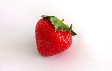 Fresh strawberry fruit isolated on white paper background.