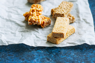 Variety of energy bars with nuts on a baking paper. Healthy snac