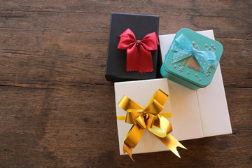 Gift boxes with ribbon on brown wooden background,Top view with copy-space