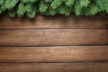 branch of christmas tree on wooden background with copy space
