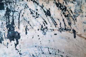 Peeling white paint on dark metal surface