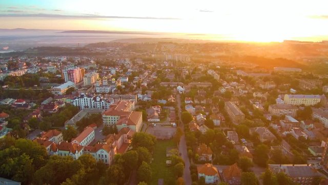 Drone flying back over the city at sunrise. FullHD 1080p.