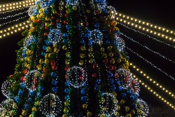 Decorated Christmas tree with multi-colored lights at night