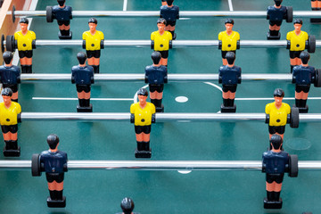 Classic foosball of playing field with rows of players