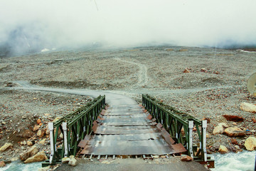 A bridge on the road in mountains