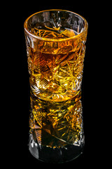 a glass of expensive whiskey on black reflection background, copy space. Degustation of elite alcohol