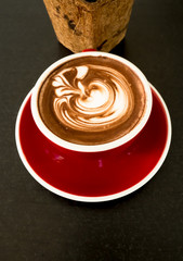 Hot tea and coffee in vintage cup with late art on wood table.