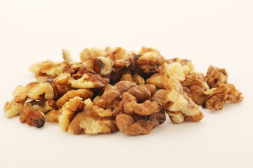 A pile of peeled walnuts at white background
