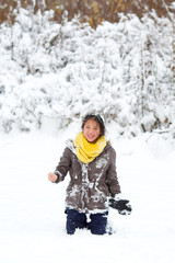 Fototapeta na wymiar Girl playing in the snow in winter in denmark