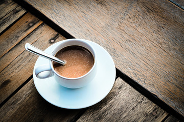 Obraz premium cup of coffee on the wooden table