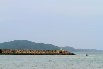 Naklejka premium barrier and rock dam, protection seawater and wave at the estuary,stones to protect the shore from the surf of the sea waves
