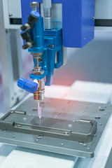 Robot holding glue syringe Injection in mobile phone factory