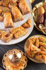 baklava with pistachio. turkish traditional delight on a dark wood background