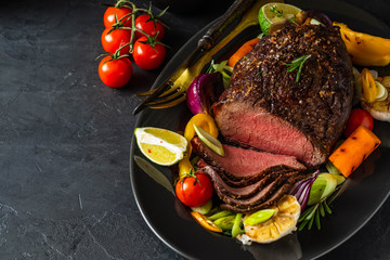 Club Beef steak with pepper sauce and Grilled vegetables on dark wooden background. Roas beef. Copy space.