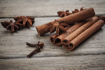 Cinnamon sticks on wooden background.