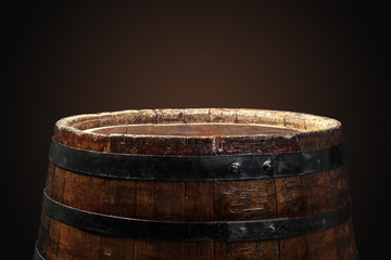 Old wooden barrel on a dark background