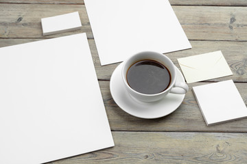 Obraz na płótnie Canvas Mock up set of id template, notebook and cup of coffee. Coffee break background