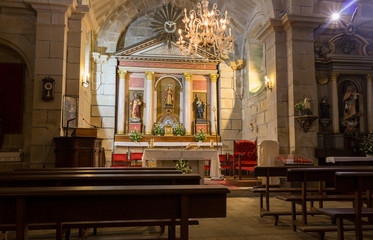 Empty catholic cathedral. Church altar with chandelier, saint sculptures and benches. Faith and...
