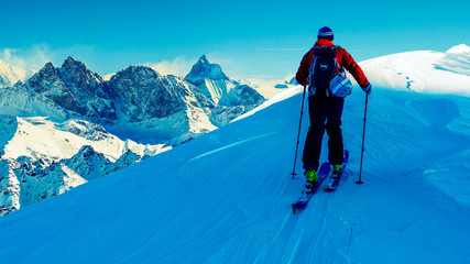 Ski with amazing view of swiss famous mountains in beautiful winter snow Mt Fort. The skituring, backcountry skiing in fresh powder snow.