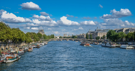 River Sena, Paris, France - July 30, 2018: Panoramic view of the Seine river with the Notre Dame cathedral on a sunny day