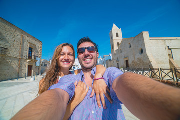 handsome tourist couple travelling in south of italy, looking cityscape of Matera, Basilicata, unesco site, capital of culture 2019. selfie photo 