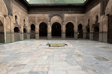 Obraz premium Inside interior of The Madrasa Bou Inania ( Medersa el Bouanania ) is acknowledged as an excellent example of Marinid architecture. Souk Medina of Fez