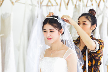 Asian designer working in wedding fashion store shop