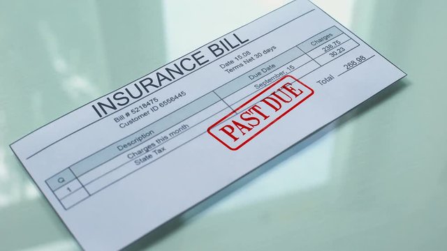 Insurance bill past due, hand stamping seal on document, payment for services