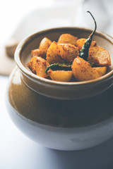 Homemade Gooseberry or amla Pickle/ or Aavle ka Achar in a bowl or barni over moody background.  selective focus