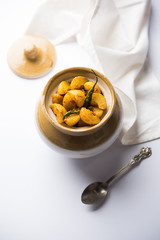 Homemade Gooseberry or amla Pickle/ or Aavle ka Achar in a bowl or barni over moody background.  selective focus