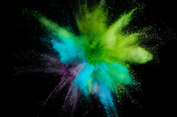 Colored powder explosion. Abstract closeup dust on backdrop. Colorful explode. Paint holi