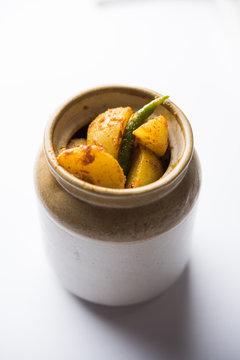 Homemade Gooseberry or amla Pickle/ or Aavle ka Achar in a bowl or barni over moody background.  selective focus