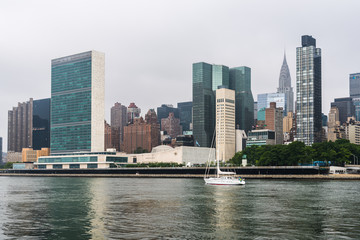 Fototapeta na wymiar Sailing ship on East River against skyline of New York City
