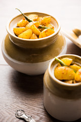 Homemade Gooseberry or amla Pickle/ or Aavle ka Achar in a bowl or barni over moody background.  selective focus