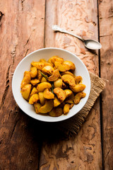 Homemade Gooseberry or amla Pickle/ or Aavle ka Achar in a bowl or barni over moody background.  selective focus