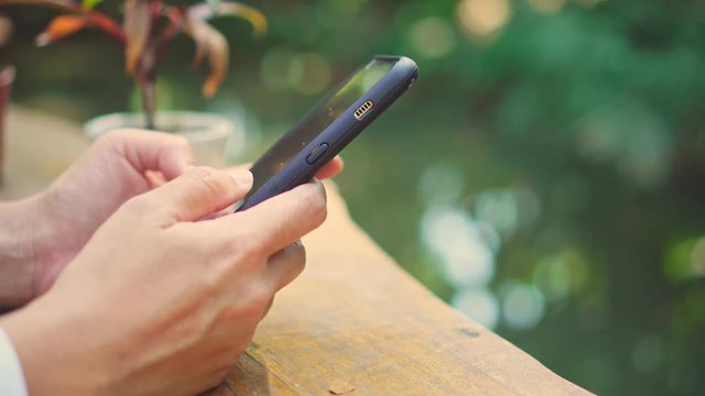 Woman hand using smartphone in  cafe background. Business, financial, trade stock maket and social network concept.