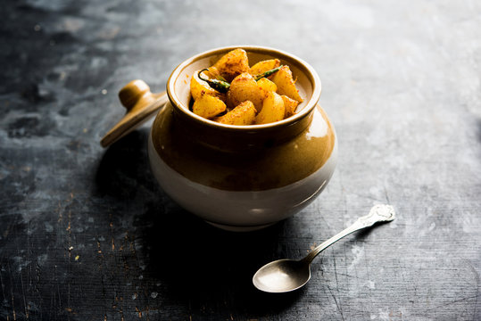 Homemade Gooseberry or amla Pickle/ or Aavle ka Achar in a bowl or barni over moody background.  selective focus