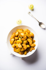 Homemade Gooseberry or amla Pickle/ or Aavle ka Achar in a bowl or barni over moody background.  selective focus