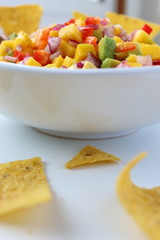 Bowl of salsa dip and nachos chips. Vegetarian food.