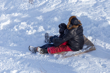 Fototapeta na wymiar People sledding from the mountain in winter