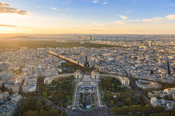 Aerial: Place du Trocadero on the background of the skyscrapers in Paris, sunset